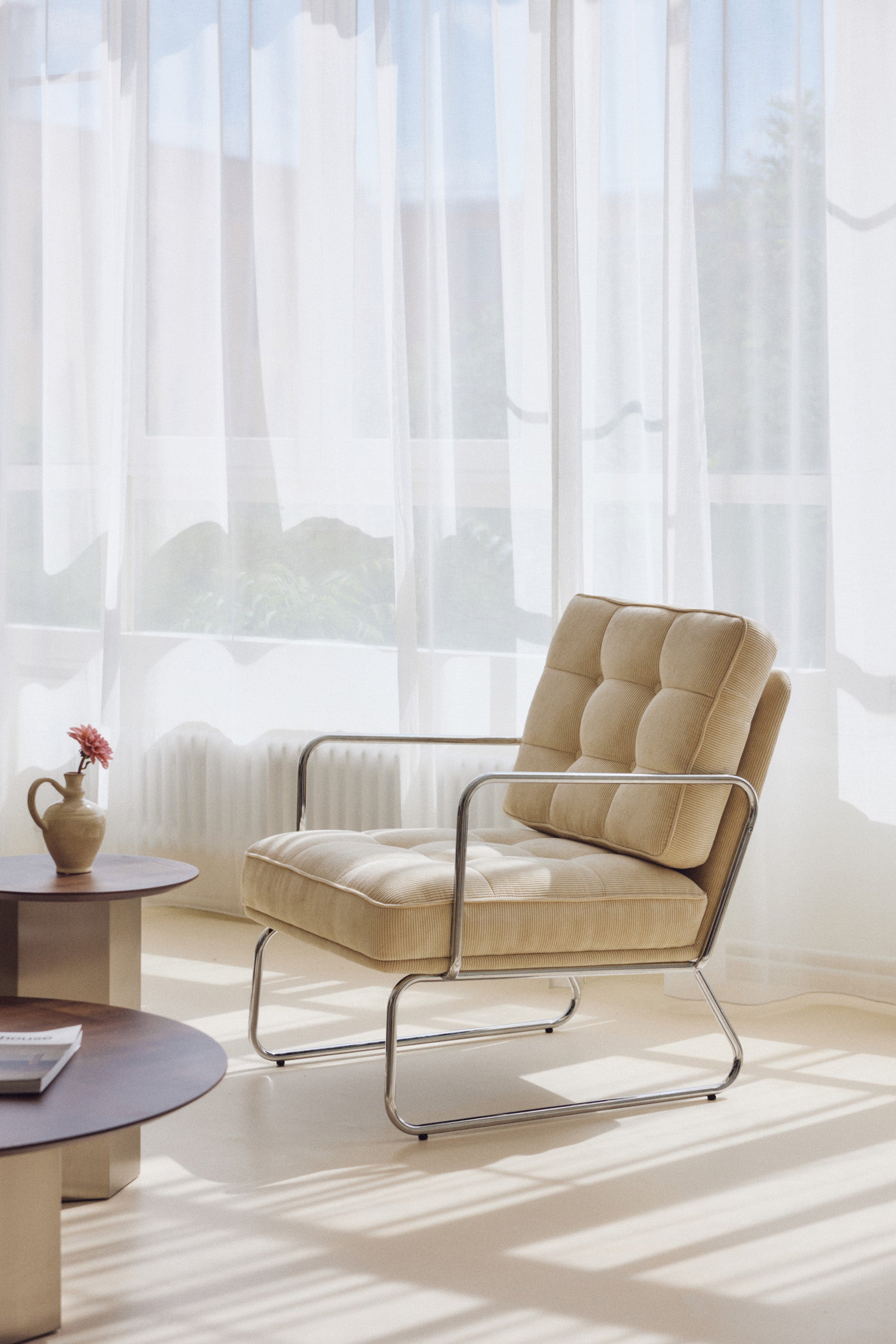 fauteuil Aurore - velours côtelé beige pampa et structure chromée - vue portrait fond voilage