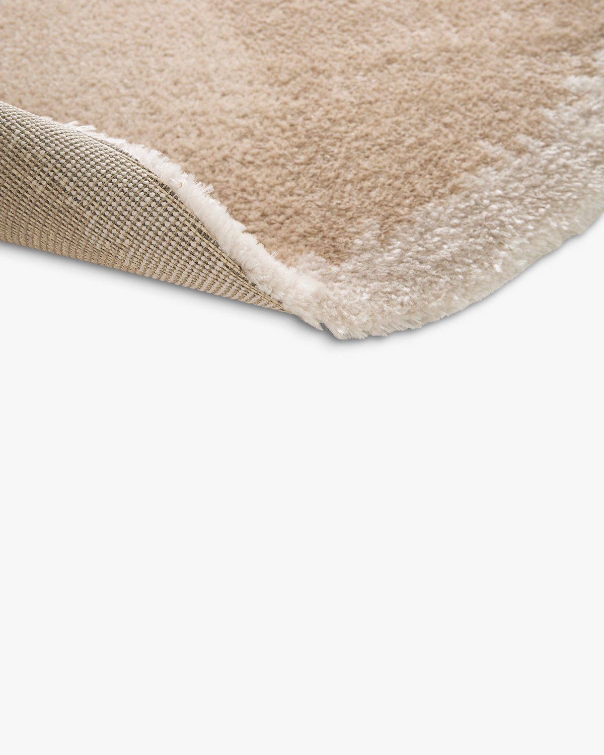 bord du tapis rond NIMBUS replié, hauteur du velours beige et envers tissé beige et écru