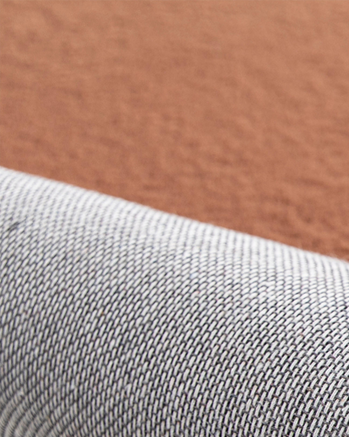 coin replié du tapis SHELL, velours brun terracotta et envers tissé écru et noir
